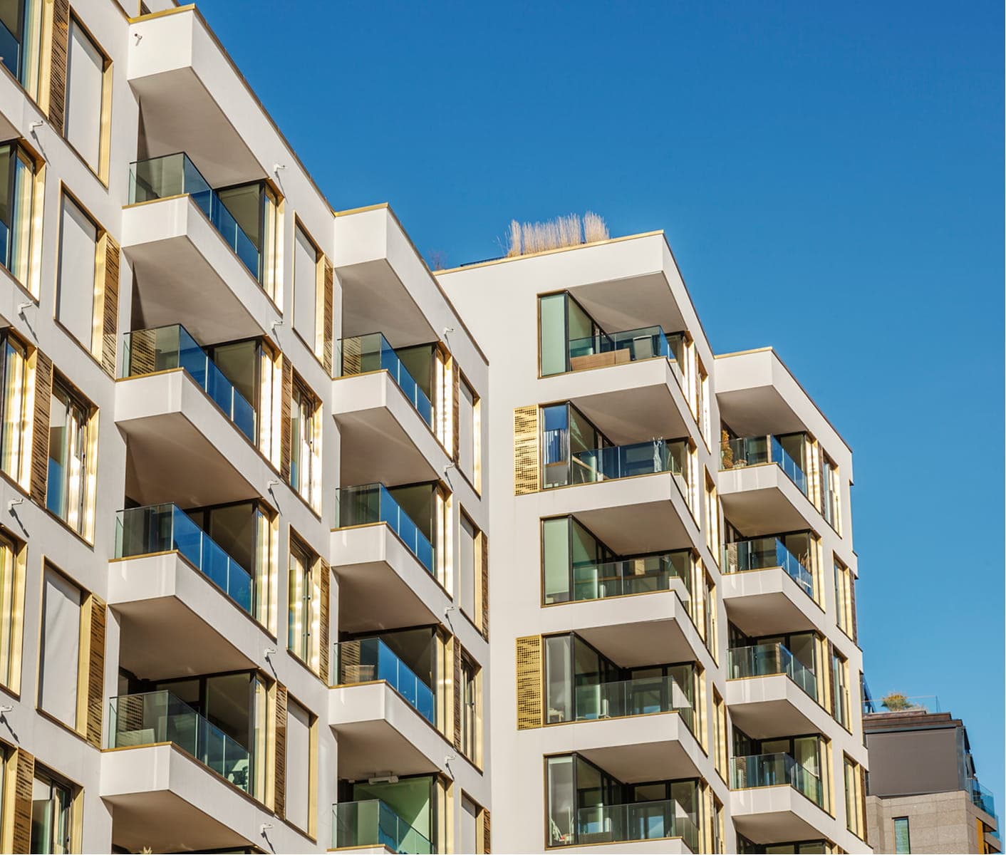 Modern apartment buildings with balconies in a newly developed residential area.