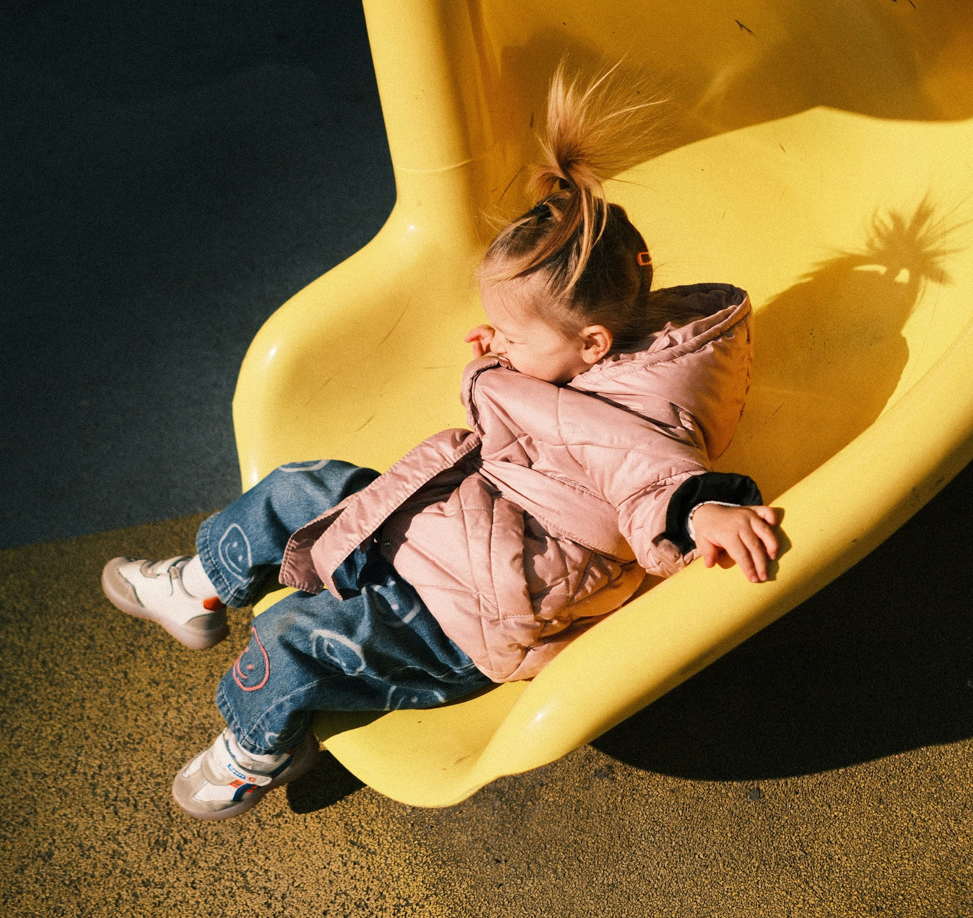 Child at a playground in an active and playful setting.