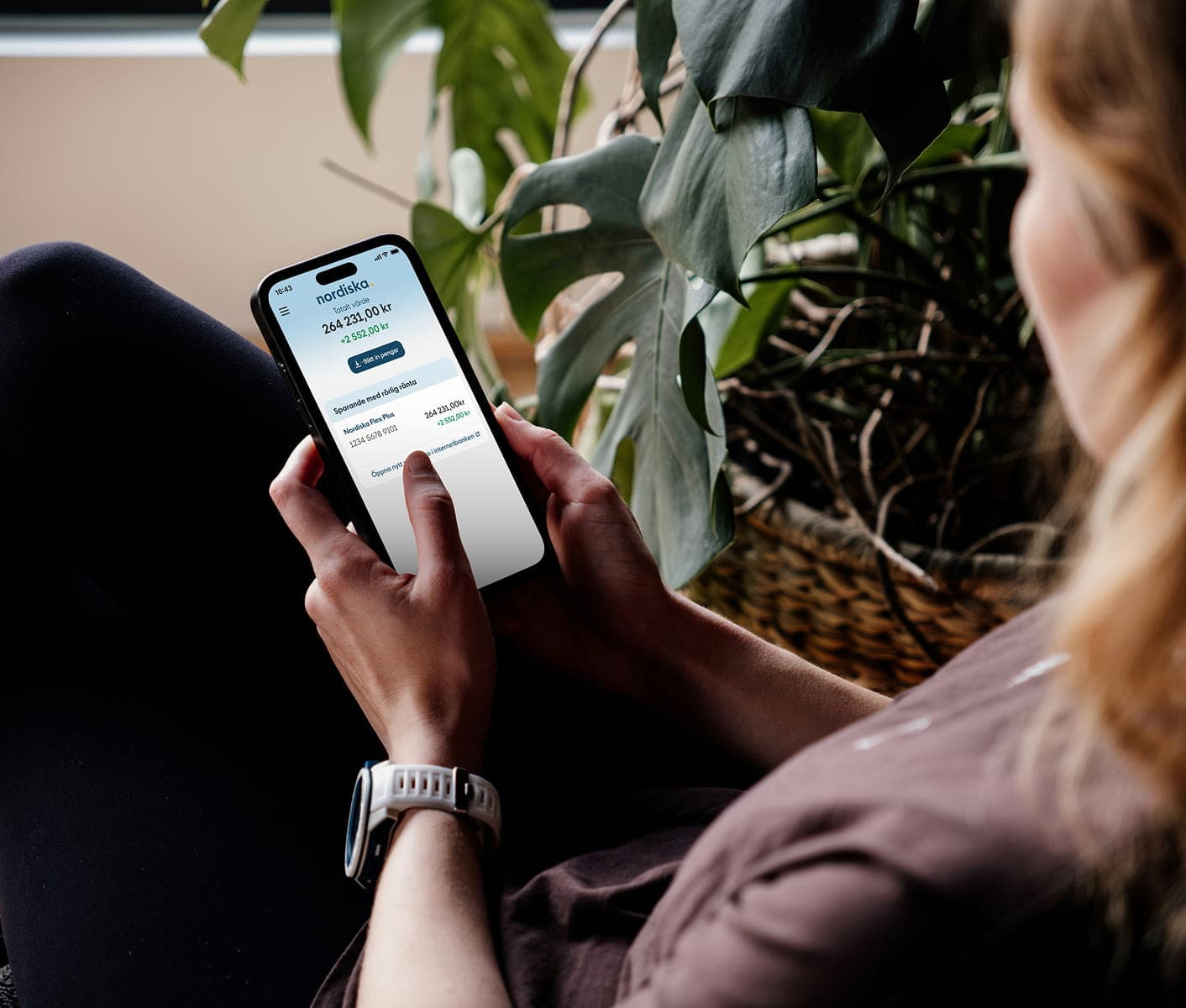 Person using a Nordiska's mobile app on their phone.