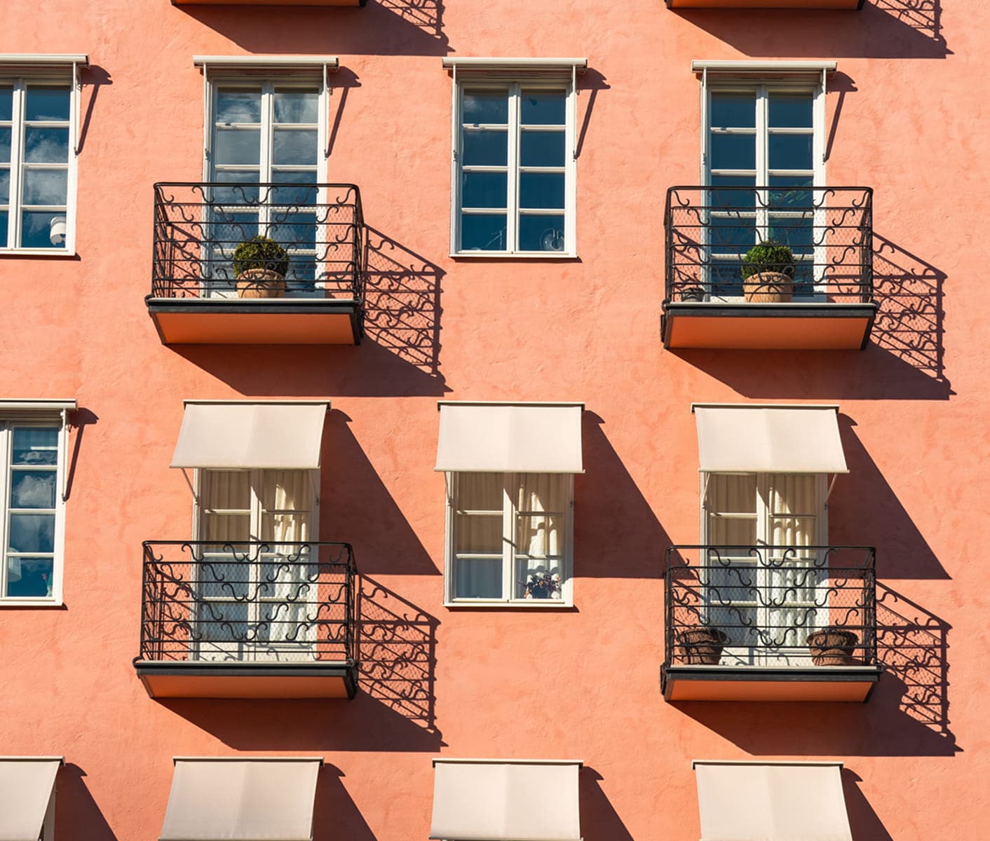 Detail of a residential property with balconies and windows.